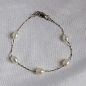 Station bracelet - 7.5inch 7mm cultured white pearl7mm cultured white freshwater pearls station bracelet in 7.5 inches. The pearls are lustrous. The chain is rhodium over copper. Matching with station necklace S001.