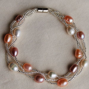 Magnetic bracelet - 7mm cultured multi pink pearl7.5 inch 7mm freshwater white, peach and pink pearls bracelet with magnetic clasp. Matching necklace is F022.
